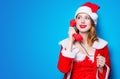 Santa Clous girl in red clothes with handset