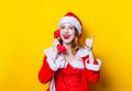 Santa Clous girl in red clothes with handset