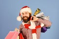 Santa with colorful packets. Guy or hipster shopper Royalty Free Stock Photo