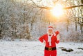 Santa coming to the winter forest with a bag of gifts, snow landscape. Royalty Free Stock Photo