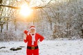 Santa coming to the winter forest with a bag of gifts, snow landscape. Royalty Free Stock Photo