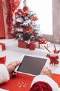 Santa connecting with a tablet Royalty Free Stock Photo