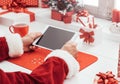 Santa connecting with a tablet Royalty Free Stock Photo