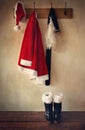Santa costume with boots on coatrack Royalty Free Stock Photo
