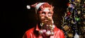 Santa decorating beard. Concept of santa man with toy balls in long beard, x-mas decorations.