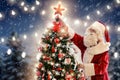 Santa decorating Christmas tree Royalty Free Stock Photo