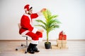 Santa decorating a tree