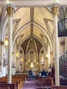 Loretto Chapel interior includes arched ceiling, pillars, and historic staircase