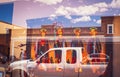 2017_07_19_Santa Fe USA - Reflections in shop window in Santa Fe New Mexico showing neon sign and truck and Native America