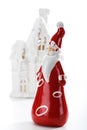 Santa figurine standing in front of winter house