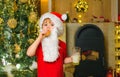 Santa fun. Merry Christmas. Santa - funny child picking cookie. Santa Claus takes a cookie on Christmas Eve as a thank