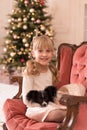 Santa gave the girl a dog for Christmas. Christmas tale. Happy childhood. First pet