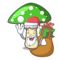 Santa with gift green amanita mushroom mascot cartoon