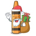 Santa with gift orange crayon in a cartoon wallet Royalty Free Stock Photo