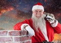 Santa with gift sack leaning on chinmey Royalty Free Stock Photo