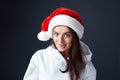 Santa Girl. Beautiful Woman In Christmas Hat Portrait. Model Biting Lips And Looking At Camera. Royalty Free Stock Photo