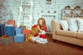 Santa girl holding Christmas gifts. happy woman in santa hat looking opening Christmas present Royalty Free Stock Photo