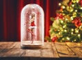 Santa girl inside a Christmas snow globe. Royalty Free Stock Photo