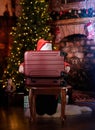 Santa girl is looking inside a suitcase