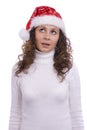 Santa girl in red Christmas cap is looking up Royalty Free Stock Photo