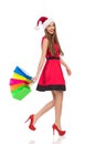 Santa girl walking with shopping bags Royalty Free Stock Photo