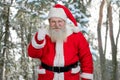 Santa giving thumb up outdoors. Royalty Free Stock Photo