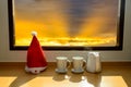 Santa hat with coffee mug near window Royalty Free Stock Photo