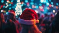 Santa hat glowing in crowd of partygoers . Royalty Free Stock Photo