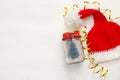 santa hat and mason jar with christmas tree