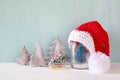 santa hat on mason jar with christmas tree