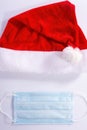 Santa hat with a protective mask on a white background, top view. christmas coronavirus concept Royalty Free Stock Photo