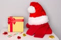 Santa hat, red sweater, gift box, candy cane on table. Waiting for Christmas. Christmas preparations