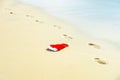 Santa Hat on the sea. Christmas on summer sea background. Tropical paradise, ocean beach texture for new year banner. Royalty Free Stock Photo