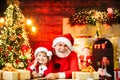 Santa helper Christmas helper and Santa writing or reading letter home near the Christmas tree. Wish List for Santa. Royalty Free Stock Photo