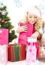 Santa helper girl with gifts and christmas tree