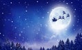 Santa and his sleigh flying over snowy landscape Royalty Free Stock Photo