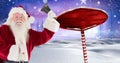 Santa holding a bell and Wooden signpost in Christmas Winter landscape Royalty Free Stock Photo