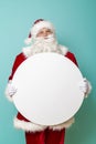 Santa holding a blank cardboard circle