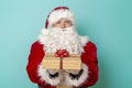 Santa holding Christmas gift box Royalty Free Stock Photo