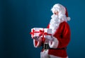 Santa holding Christmas gift boxes Royalty Free Stock Photo