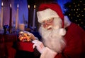 Santa Holding Christmas Present in his Hands Royalty Free Stock Photo