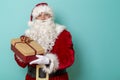 Santa holding Christmas present Royalty Free Stock Photo