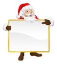 Santa holding Christmas sign and pointing Royalty Free Stock Photo