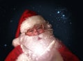 Santa holding magical Christmas lights in hands Royalty Free Stock Photo