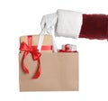 Santa holding paper bag with gift boxes on white background, closeup Royalty Free Stock Photo