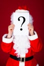 Santa holding question mark in front of his face