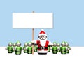 Santa holding a sign surrounded by all his helpers