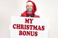 Santa is holding a white sign with the inscription - My Christmas bonus Royalty Free Stock Photo