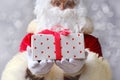 Santa holds a big red box, gifts, sales, shows the postage, the concept of the international holiday delivery of goods, christmas