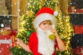 Christmas kids in snow. Santa in home. Santa Claus eating cookies and drinking milk on Christmas Eve. Kid Santa Claus Royalty Free Stock Photo